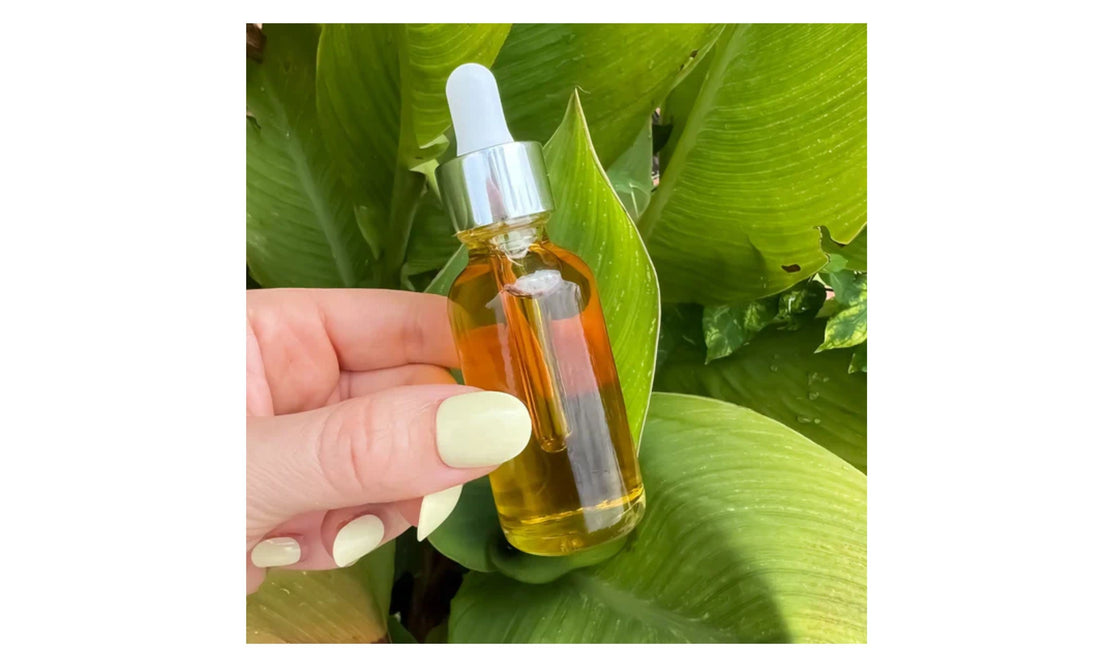 Indigo Private Label Bakuchiol Serum dropper bottle held against lush green leaves.