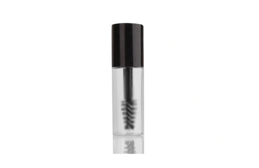 Indigo Private Label clear brow gel in a transparent tube with a black cap and spoolie brush.