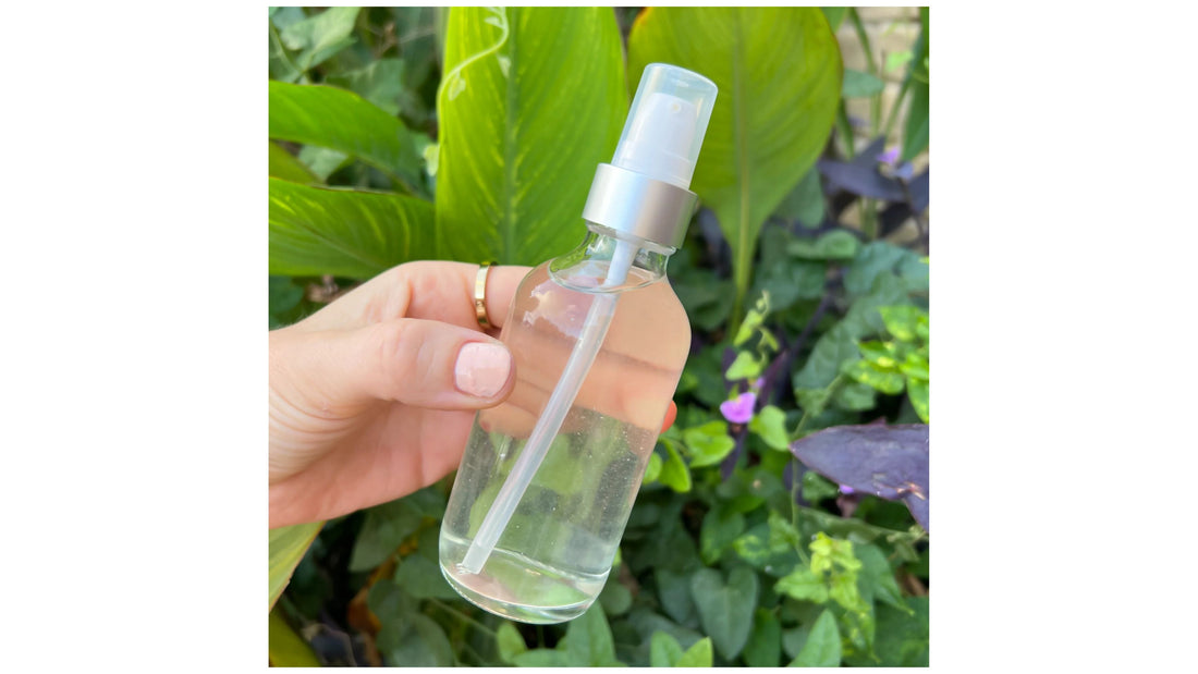 Indigo Private Label balancing face toner bottle held outdoors against garden background.