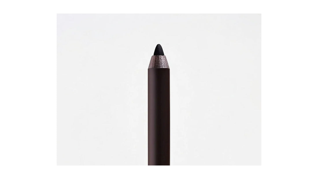 Matte black eye pencil with sharpened tip by Indigo Private Label, shown on an off-white background
