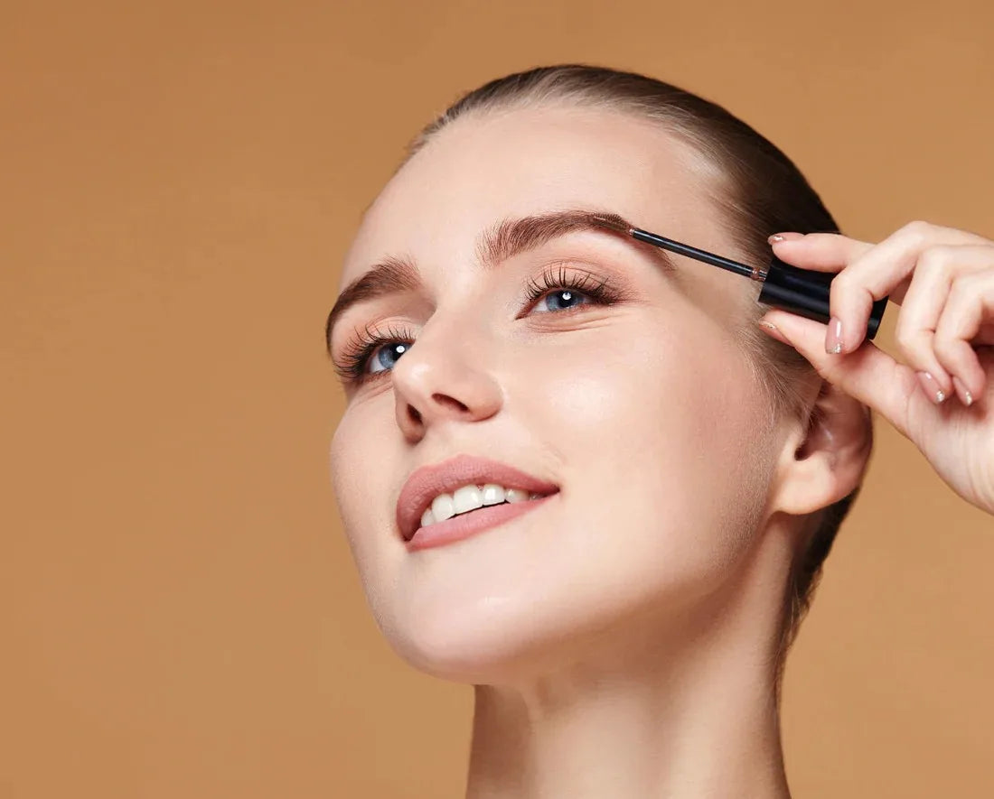 A model applying brow gel to showcase easy brow grooming and product use from Indigo Private Label.