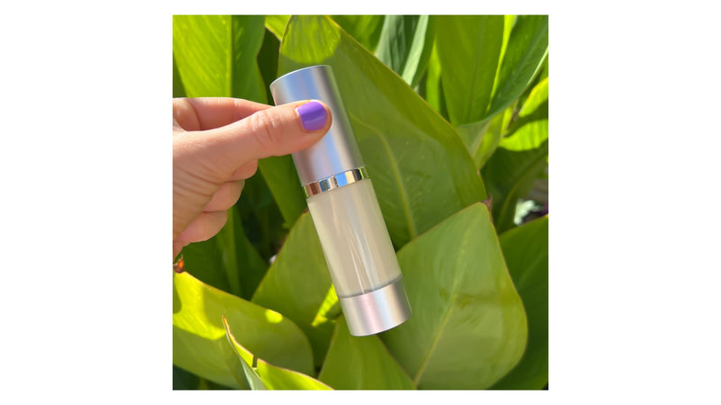  Indigo Private Label nighttime moisturizer in airless pump packaging held against a natural leafy background.
