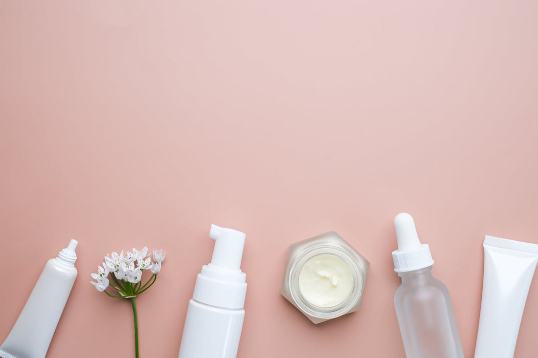 The skincare and cosmetic serum on a pink flatlay background.