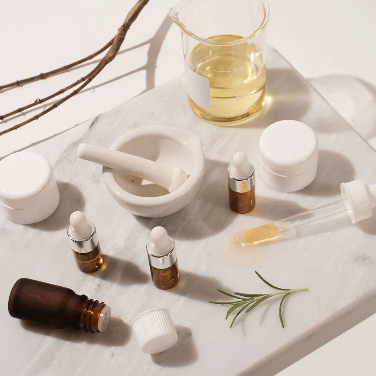  Indigo Private Label formulation setup with amber bottles, white jars, a beaker, and a mortar and pestle.