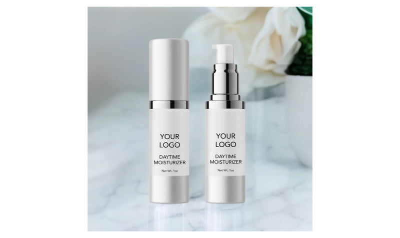 Indigo Private Label daytime moisturizer bottles with custom logo labels on a clean marble surface.